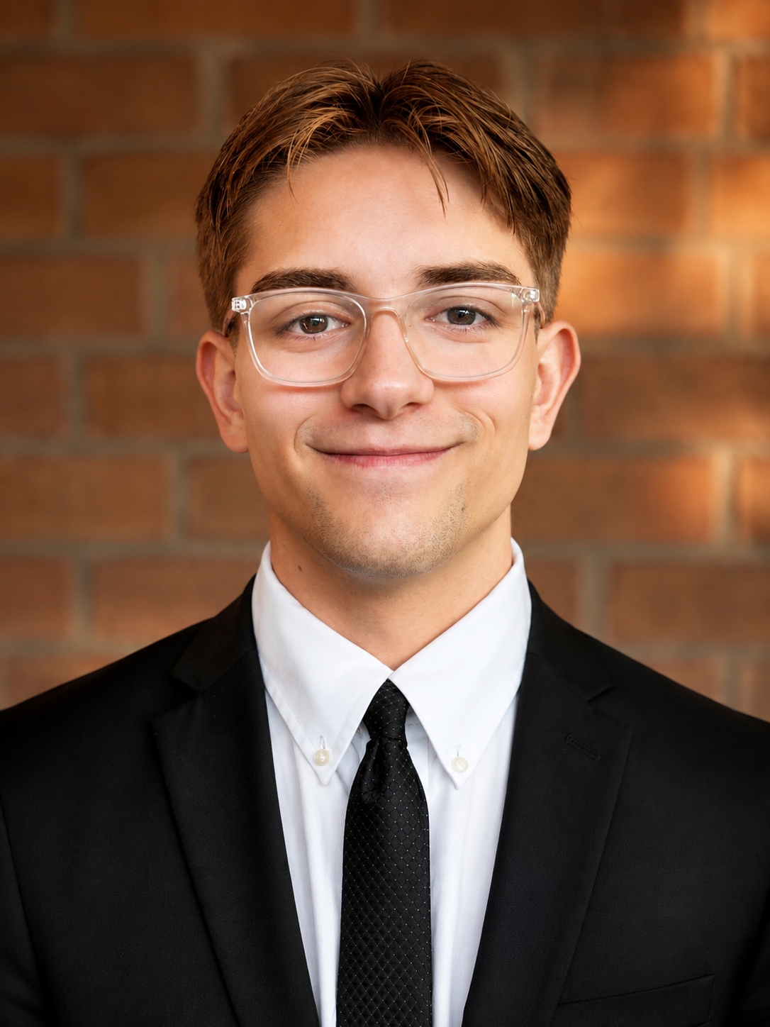 Corbin Rollins in a suit and tie after getting his missionary haircut